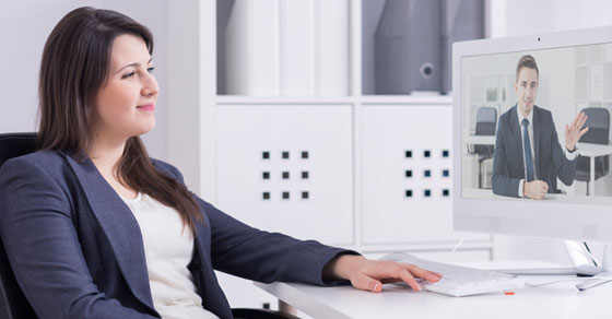 Business woman having a teleconference meeting on computer