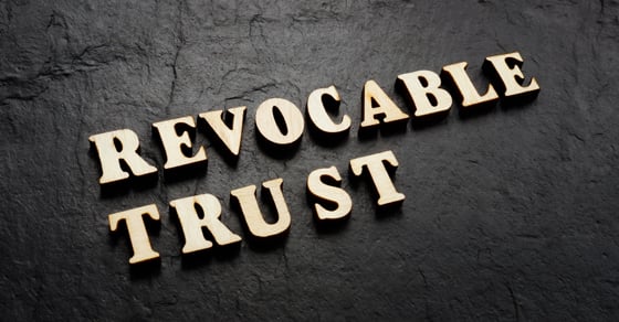 The words "Revocable Trust" displayed on top of a black concrete background.
