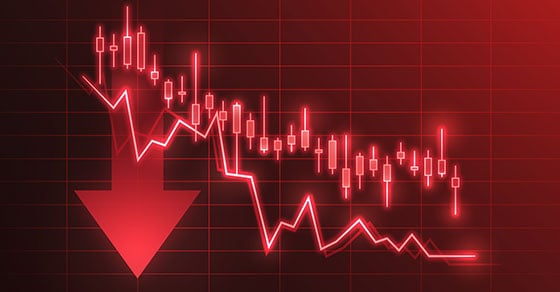 A red line chart for stocks that's descending toward the right side of the image, with a red arrow pointing downward on the left side.