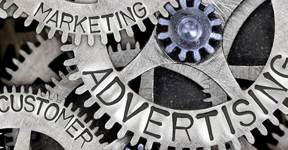 Overlapping metal cog wheels that have the words "Advertising", "Marketing", and "Customer" on them.