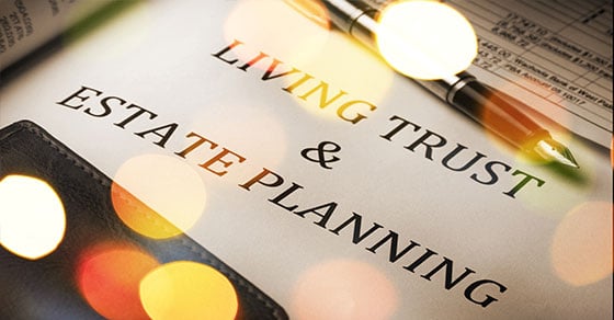A pen and paper with "Living Trust and Estate Planning" written on it.