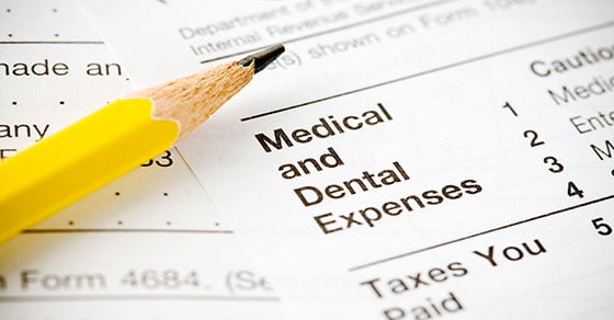 An close view of paperwork that reads "Medical and Dental Expenses" and a pencil.