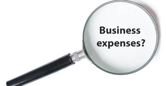 A magnifying glass with the words "Business expenses?" inside of it.
