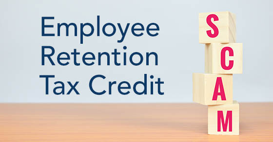 A wooden surface with blocks that spell out SCAM stacked on top of it, with the words "Employee Retention Tax Credit" edited onto the image in front of the blocks.