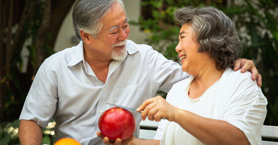 A couple looking at each other while smiling and laughing.