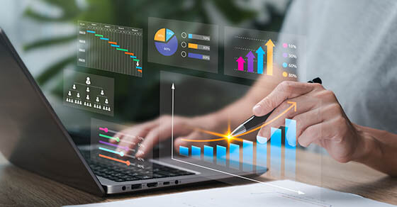 Someone working on a laptop with carious charts overlaying the image. The person appears to be interacting with the charts.